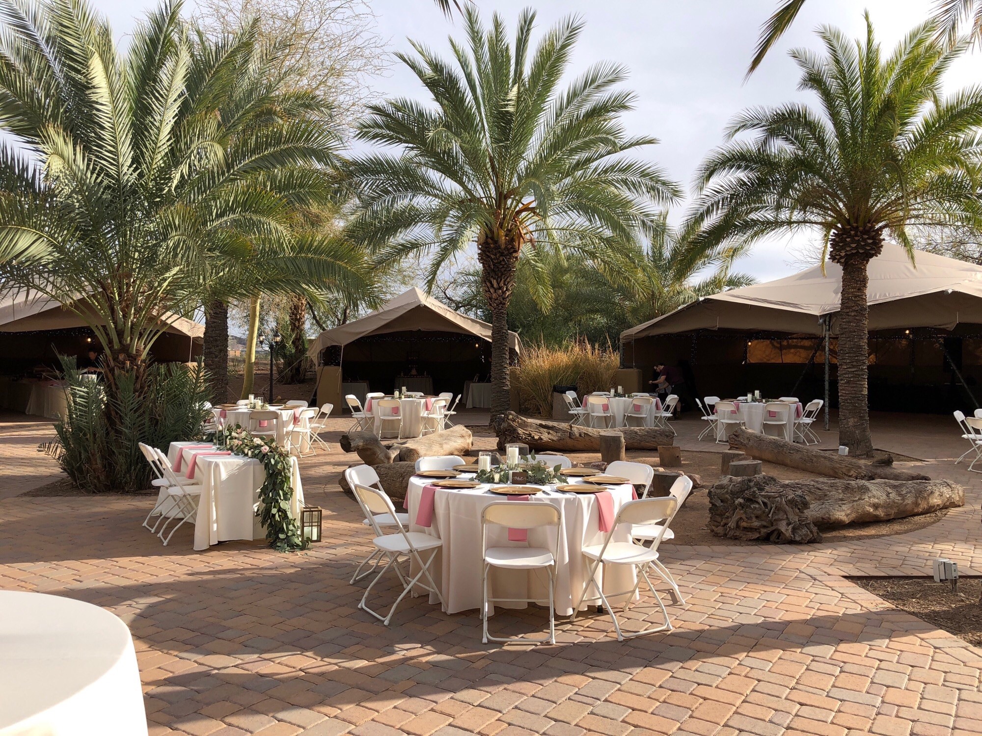 The wedding venue during the day showing tents and tables