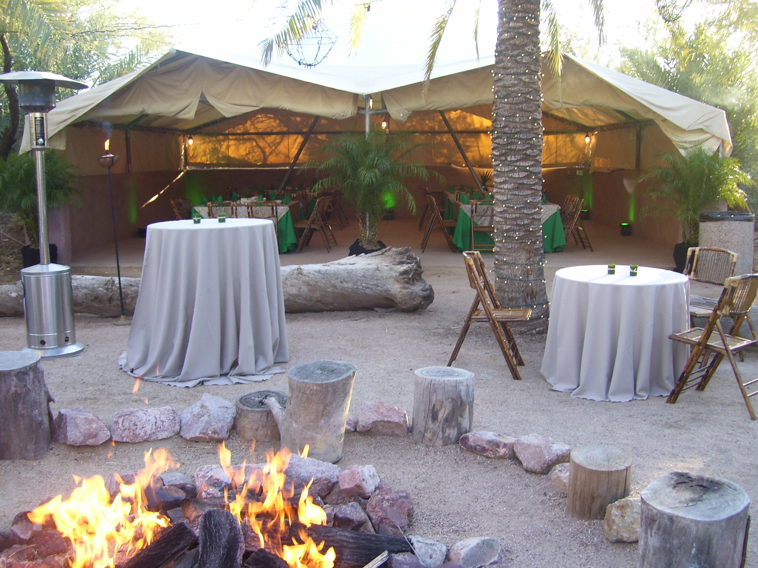 Tents and talbes around a fireplace at the wedding venue